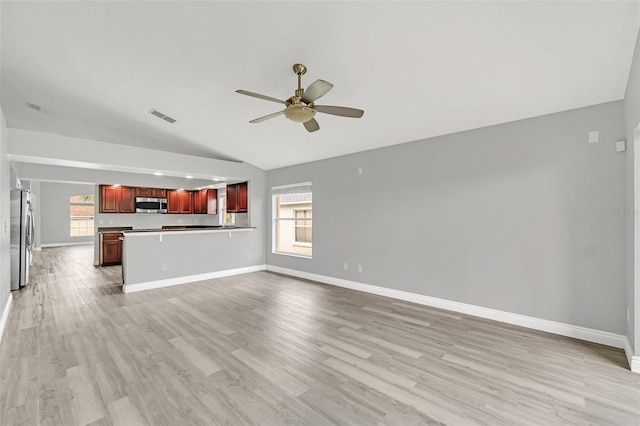 unfurnished living room featuring ceiling fan, light hardwood / wood-style floors, and vaulted ceiling