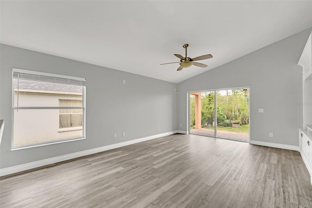 spare room with lofted ceiling, light hardwood / wood-style floors, and ceiling fan