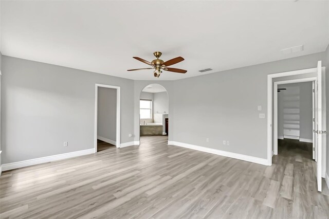 empty room with light wood-type flooring and ceiling fan