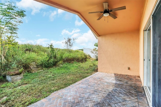 exterior space with ceiling fan