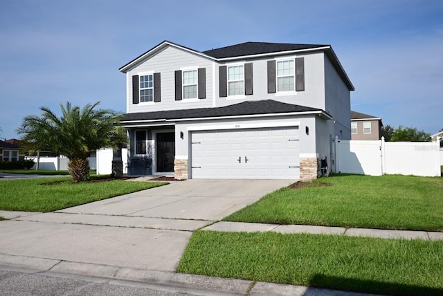 view of front property featuring a front lawn and a garage