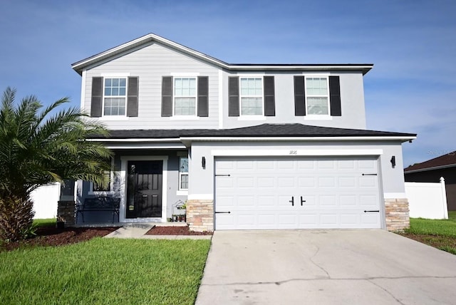 view of front of house with a garage and a front lawn