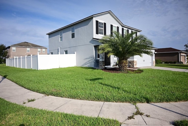 view of front of property with a front yard and a garage