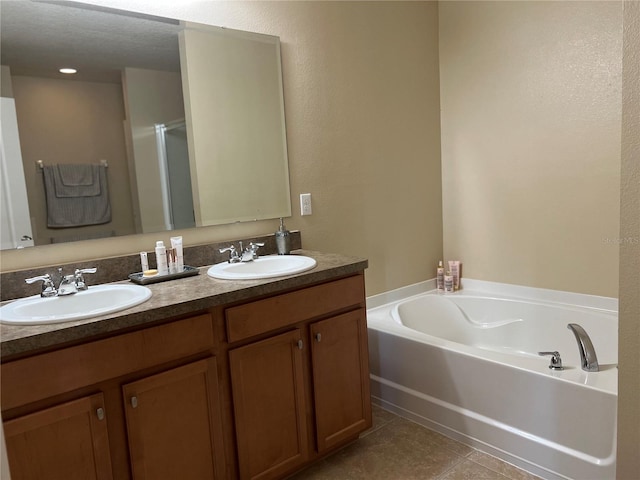 bathroom featuring a textured ceiling, tile patterned flooring, vanity, and separate shower and tub