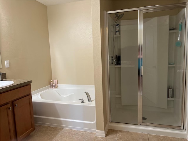 bathroom featuring independent shower and bath, vanity, and tile patterned floors