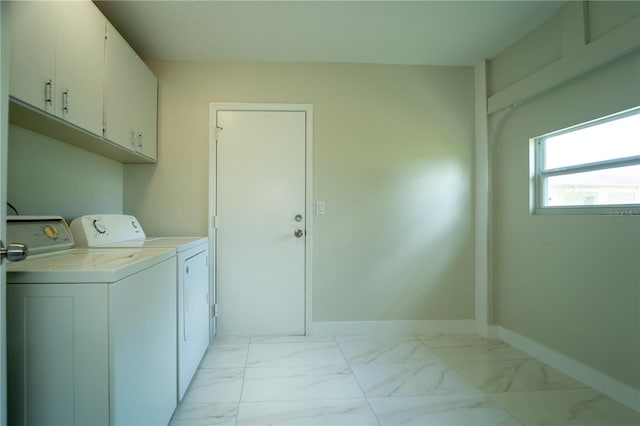 laundry area with washing machine and dryer and cabinets