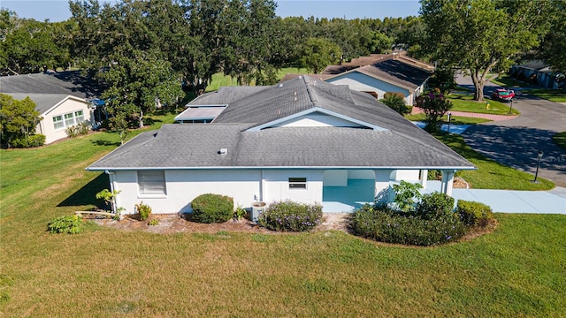 view of property exterior with a lawn and central AC