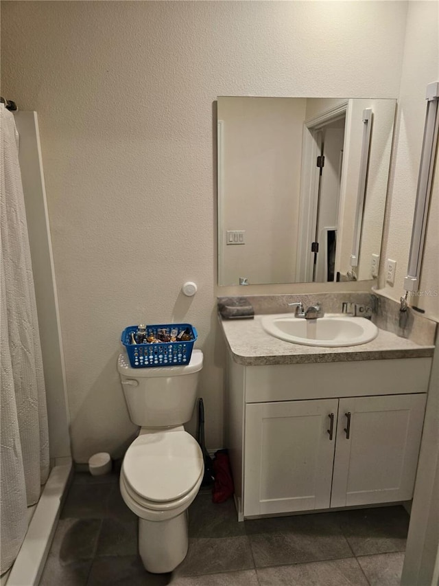 bathroom with walk in shower, vanity, toilet, and tile patterned floors