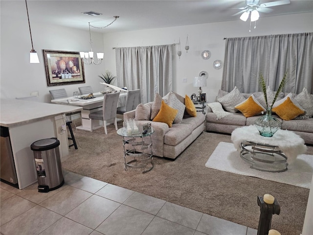 living room featuring light colored carpet and ceiling fan with notable chandelier