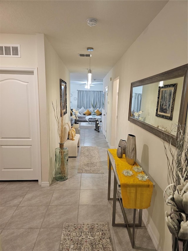 hall featuring light tile patterned flooring