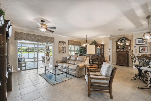 living room with light tile patterned floors, ceiling fan with notable chandelier, and ornamental molding