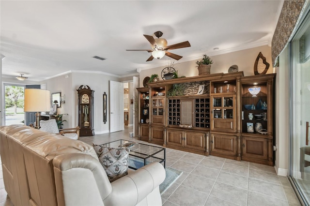 tiled living room featuring ceiling fan and ornamental molding