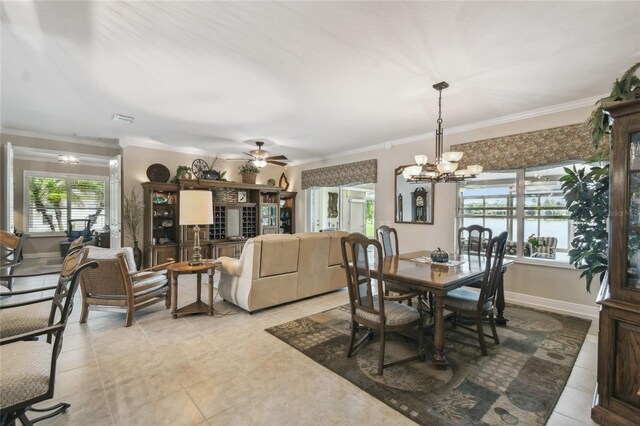 dining room with ceiling fan with notable chandelier and crown molding