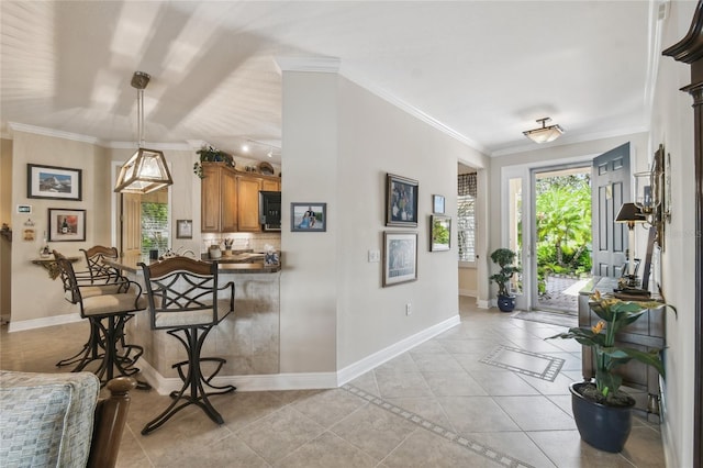 tiled entrance foyer featuring crown molding