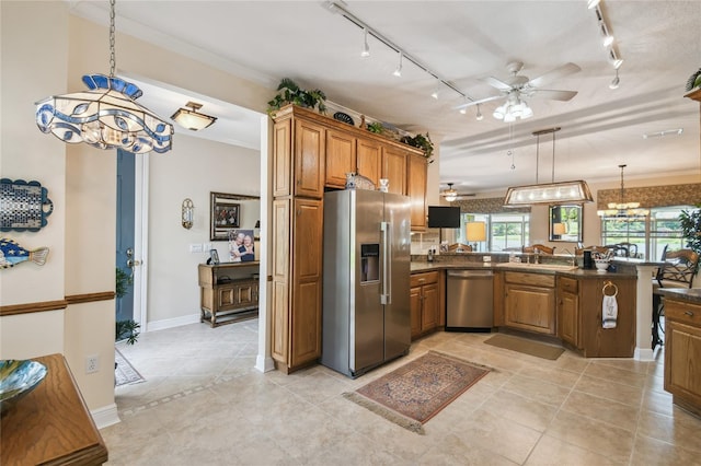 kitchen featuring hanging light fixtures, kitchen peninsula, rail lighting, stainless steel appliances, and ceiling fan with notable chandelier