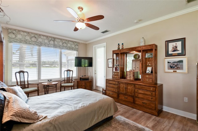 bedroom with ceiling fan, light hardwood / wood-style flooring, and crown molding