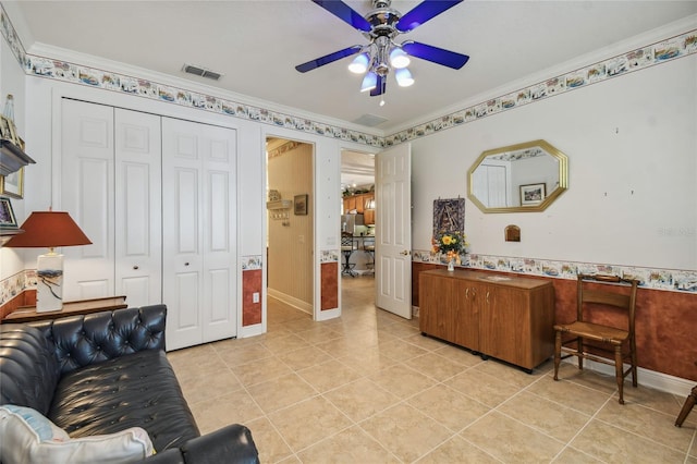 living room with ceiling fan, light tile patterned floors, and crown molding