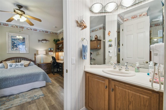 interior space featuring crown molding, ceiling fan, hardwood / wood-style flooring, and sink