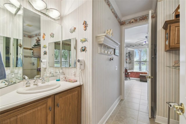 bathroom with ornamental molding, vanity, ceiling fan, and tile patterned floors