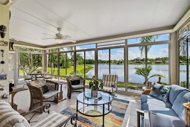 sunroom / solarium with ceiling fan, a water view, and a healthy amount of sunlight