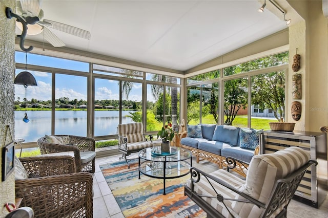 sunroom featuring a water view and a wealth of natural light