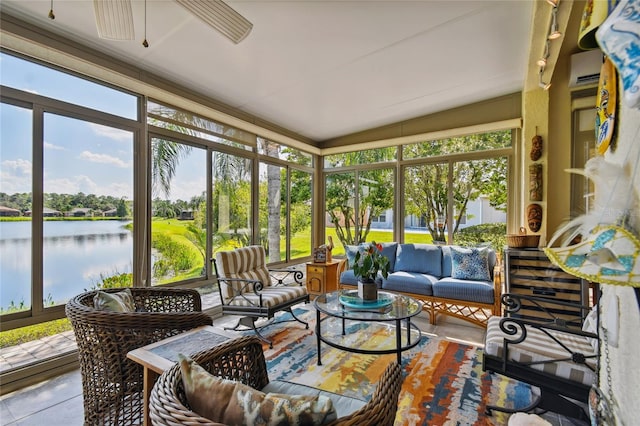 sunroom / solarium with a wealth of natural light, a water view, and ceiling fan