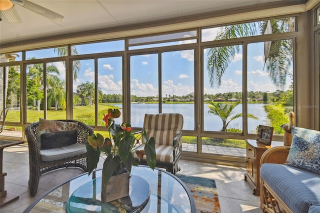 sunroom / solarium with ceiling fan and a water view