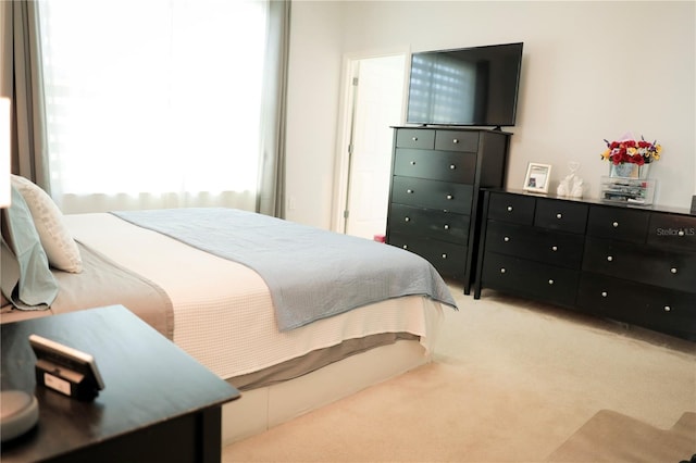 bedroom featuring light colored carpet