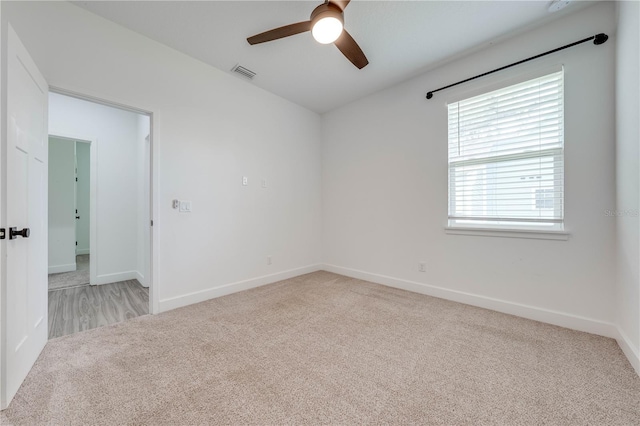 carpeted empty room featuring ceiling fan