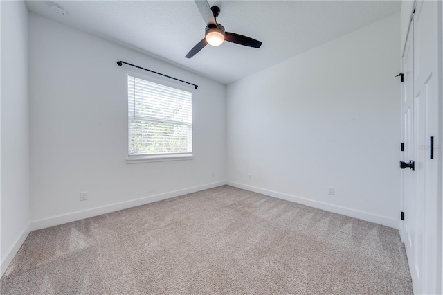 unfurnished room featuring light colored carpet and ceiling fan