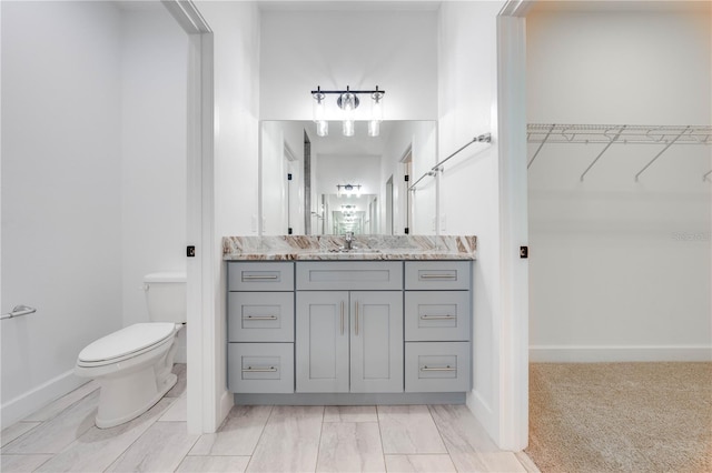 2909 Annalee Rd, Saint Cloud, FL 34771 - full bath with toilet, a spacious closet, vanity, and baseboards
