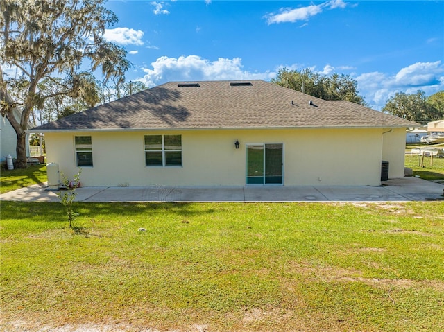 rear view of property with a yard and a patio area