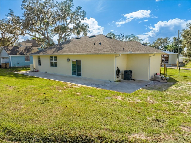 2909 Annalee Rd, Saint Cloud, FL 34771 - back of property with a patio, stucco siding, central AC unit, and roof with shingles