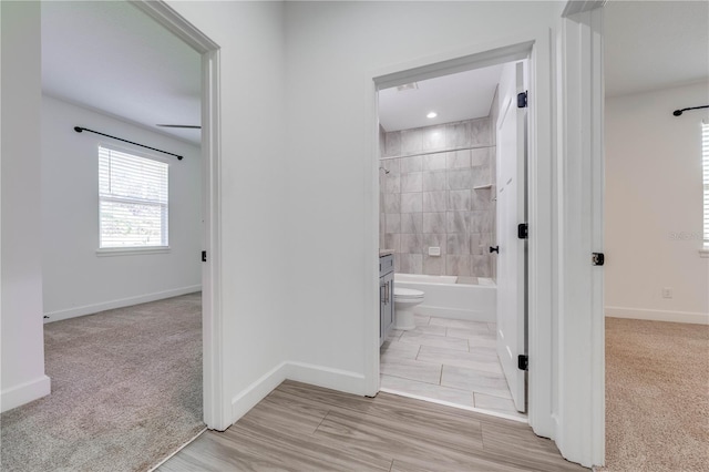 full bath featuring vanity, toilet, shower / tub combination, and baseboards