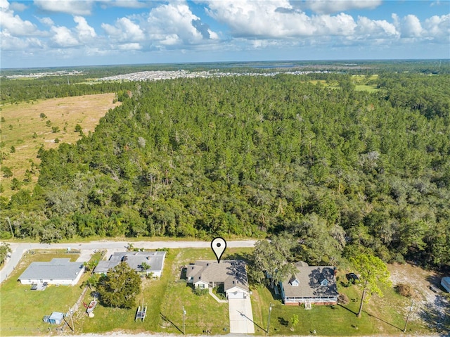 birds eye view of property featuring a wooded view