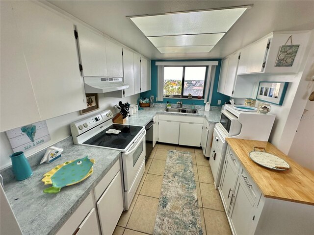 kitchen featuring white cabinetry, white range with electric cooktop, and light tile patterned floors