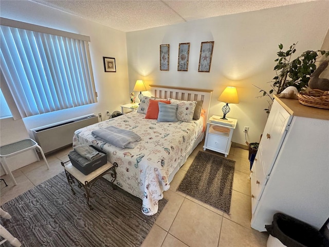 bedroom featuring light tile patterned flooring and a textured ceiling