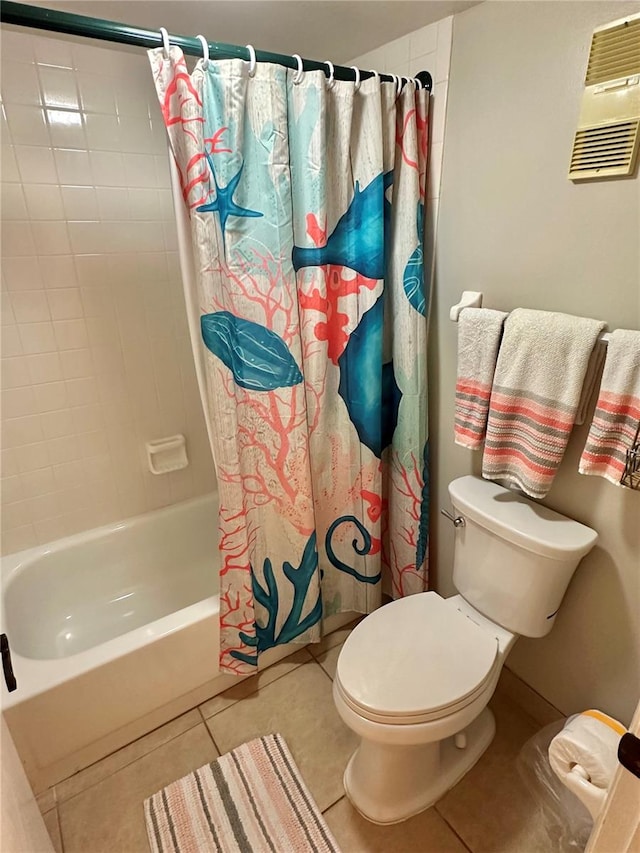 bathroom featuring shower / tub combo with curtain, tile patterned flooring, and toilet