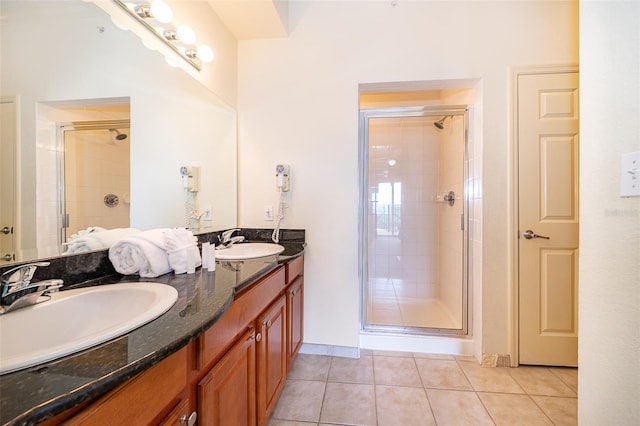 bathroom featuring vanity, a shower with door, and tile patterned floors