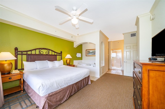 bedroom featuring connected bathroom, ceiling fan, light colored carpet, and crown molding