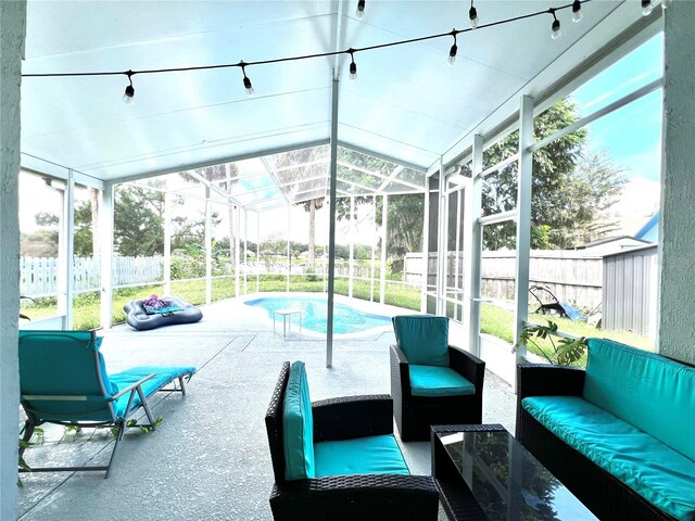 sunroom / solarium with lofted ceiling and a wealth of natural light