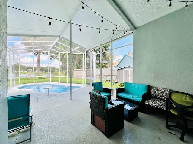exterior space with a patio area, an outbuilding, glass enclosure, fence, and a storage unit