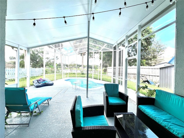 exterior space with outdoor lounge area, a patio area, fence, and glass enclosure