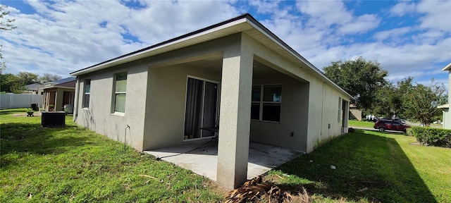 view of home's exterior featuring a yard and a patio