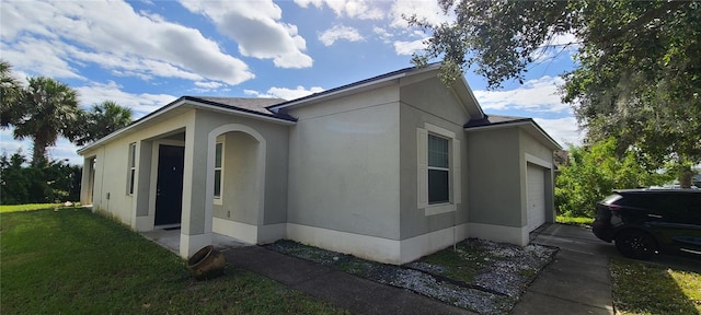 view of property exterior featuring a yard and a garage