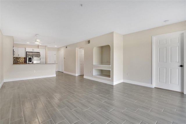 unfurnished living room featuring light hardwood / wood-style flooring and ceiling fan