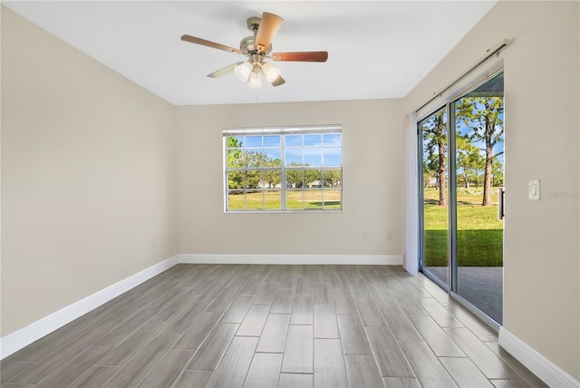 spare room with hardwood / wood-style floors and ceiling fan