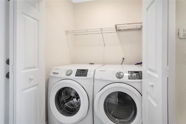 laundry area with washing machine and clothes dryer