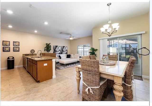 dining space featuring sink, light tile patterned floors, and a notable chandelier