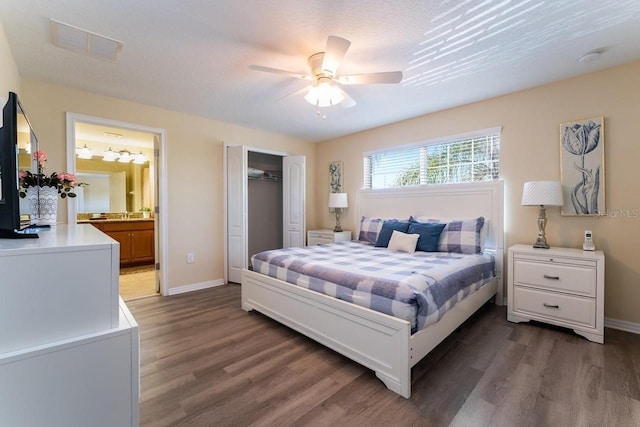 bedroom featuring ceiling fan, a closet, dark hardwood / wood-style floors, and ensuite bathroom